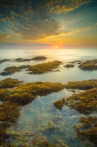 Scenic view of sea against sky at sunset