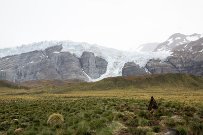 Scenic view of landscape and mountains against sky