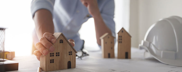 Midsection of woman standing on table at home