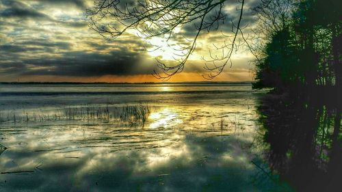 Scenic view of lake against cloudy sky