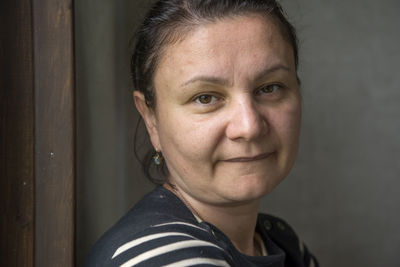 Portrait of confident woman biting lip at home