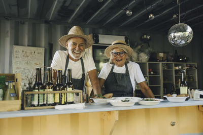 Portrait of smiling male and female owners in food truck