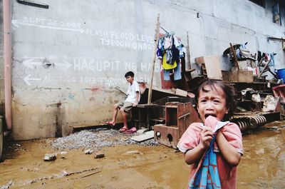 Portrait of smiling boy standing on floor