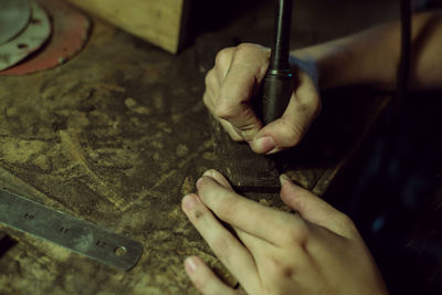 Cropped image of worker working on machinery