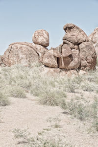 Rock formations on landscape against clear sky