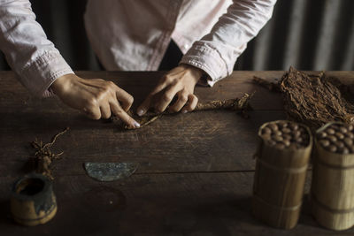 Midsection of woman working on tobacco factory