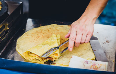 Close-up of person preparing food at kitchen