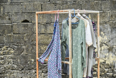 Close-up of clothes drying against brick wall