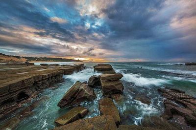 Scenic view of sea against cloudy sky