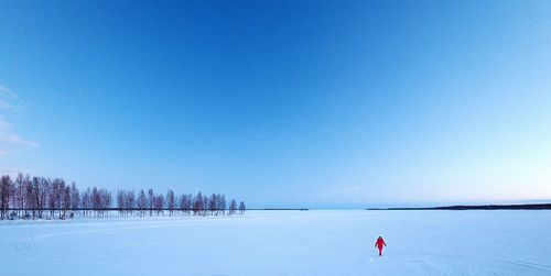 Scenic view of snow covered landscape against blue sky