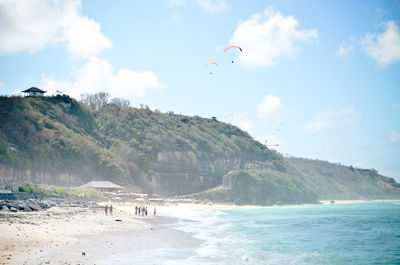 Scenic view of sea and mountains against sky
