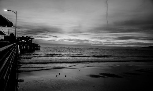 View of beach against cloudy sky