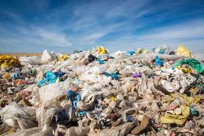 Stack of garbage in house against sky