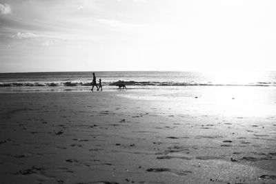 Father and son walking in kedonganan beach