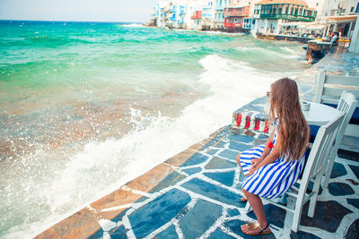 Woman sitting in swimming pool at beach