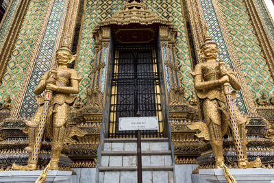 Low angle view of statue against temple building