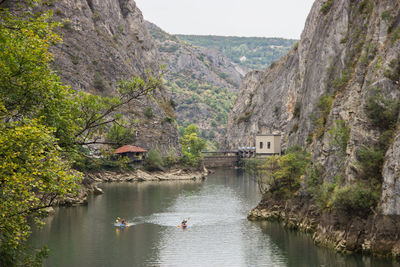 Scenic view of river by mountains against sky