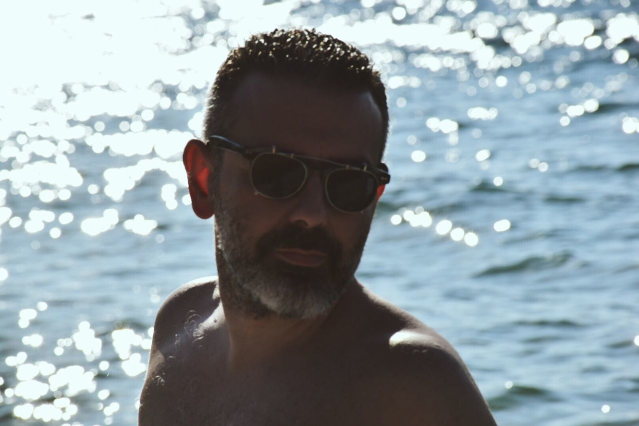 headshot, sunglasses, lifestyles, person, young adult, water, leisure activity, young men, portrait, looking at camera, focus on foreground, close-up, head and shoulders, front view, mid adult men, mid adult, human face, day