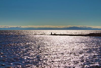 Scenic view of sea against blue sky