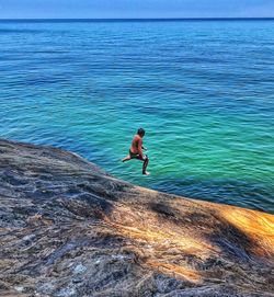 Full length of shirtless man in sea