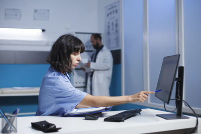 Side view of businesswoman working at office