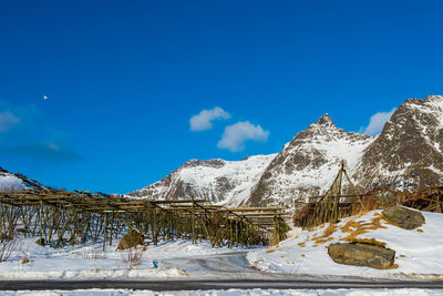 Snow covered mountain against blue sky