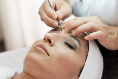 Midsection of woman lying on hand