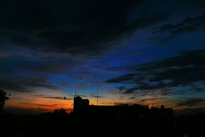 Low angle view of silhouette city against sky during sunset