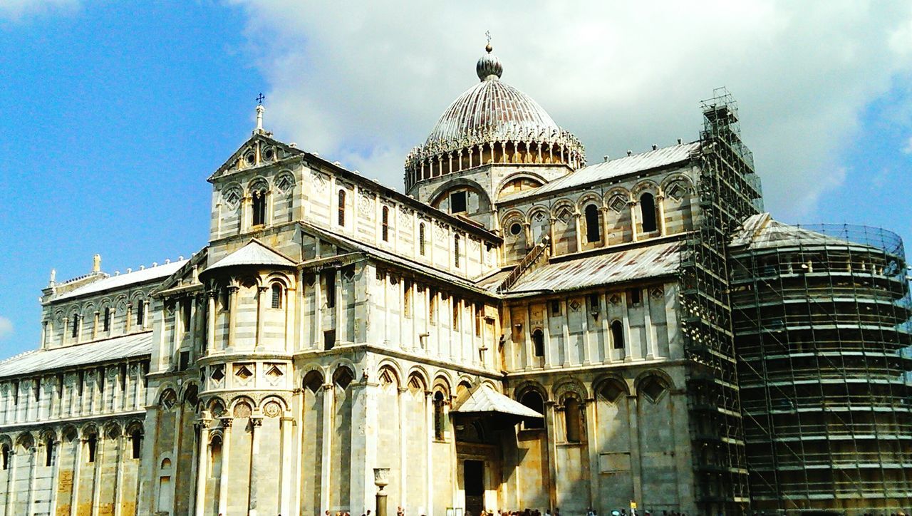 architecture, building exterior, built structure, low angle view, sky, church, religion, place of worship, facade, history, blue, spirituality, day, window, travel destinations, famous place, city, outdoors, cloud - sky