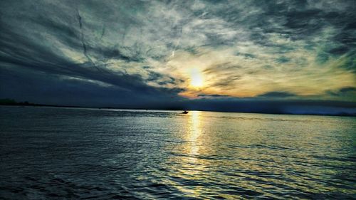 Scenic view of sea against cloudy sky