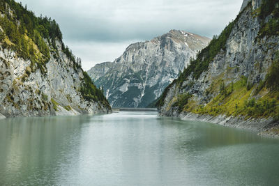 Scenic view of lake and mountains against sky