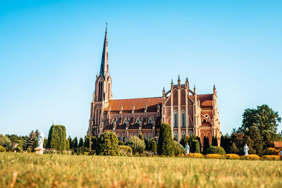 View of buildings against clear blue sky