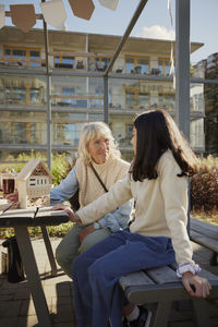 Woman and girl making bug hotels together