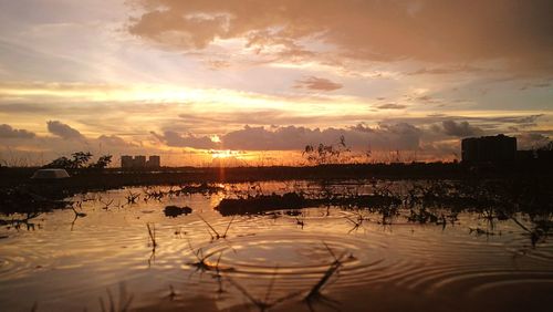 Scenic view of lake against sky during sunset