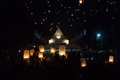 Group of people in illuminated building at night