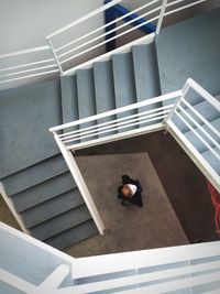 High angle view of man on staircase of building