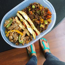 Low section of woman standing by food on table