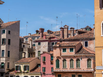 Buildings in city against blue sky