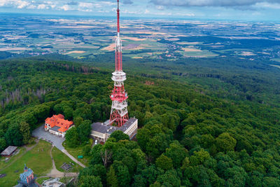 High angle view of cross amidst trees against sky