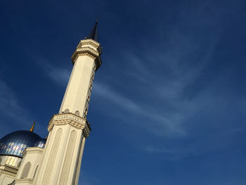 Low angle view of tower against cloudy sky