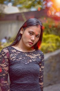 Portrait of young woman standing outdoors