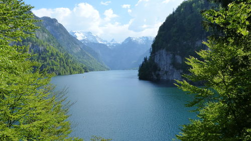 Scenic view of river amidst mountains against sky