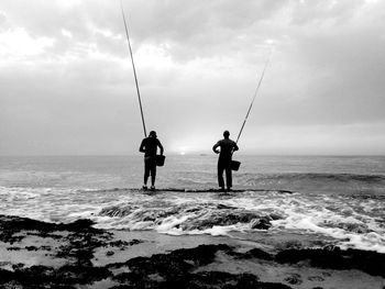 People fishing in sea
