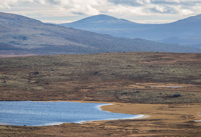 Scenic view of landscape and mountains against sky