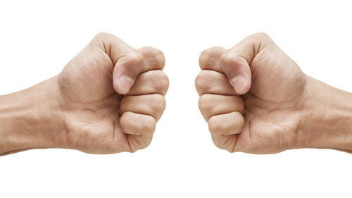 Close-up of hands against white background