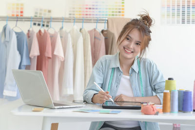 Young woman using mobile phone in office