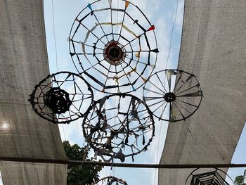 Low angle view of light fixture hanging from ceiling of building