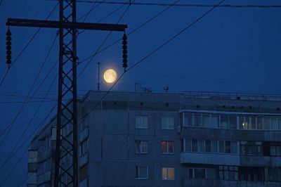 Low angle view of illuminated lights against sky at dusk