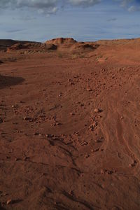 Scenic view of sand dunes against sky