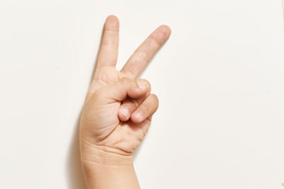 Close-up of hand holding over white background